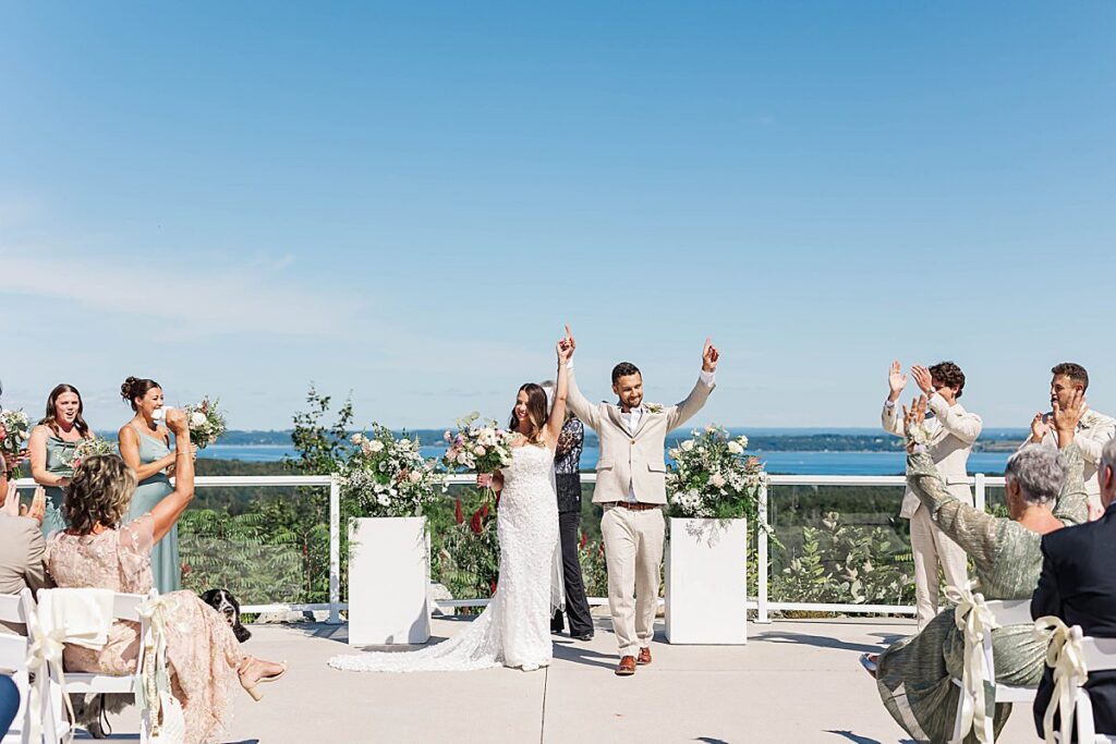Outdoor waterfront ceremony during a Northern Michigan destination wedding weekend