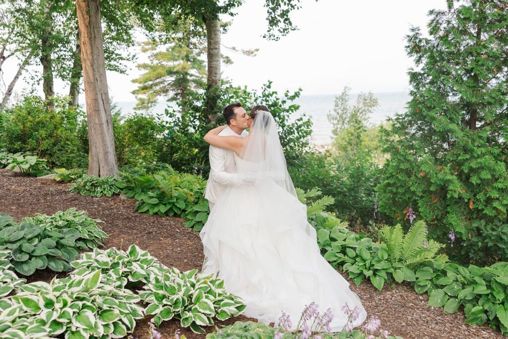 Romantic couple portrait with florals and waterfront views at a Petoskey Michigan wedding venue