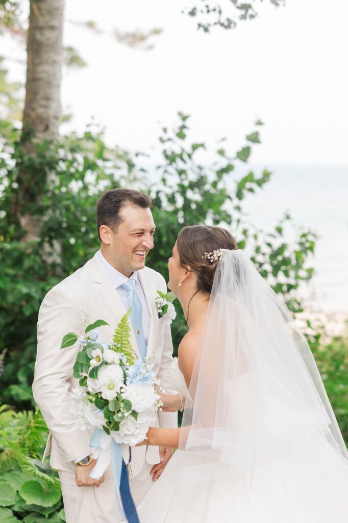 Couple smiling during their first look at Stafford’s Perry Hotel in Petoskey