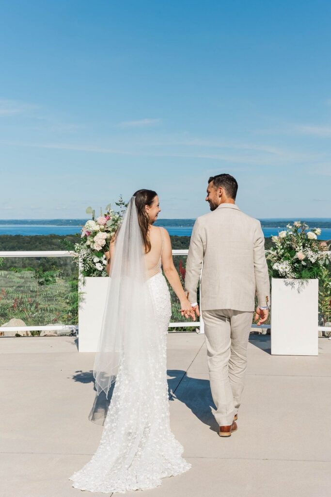 Bride and groom overlooking the water during a Northern Michigan destination wedding