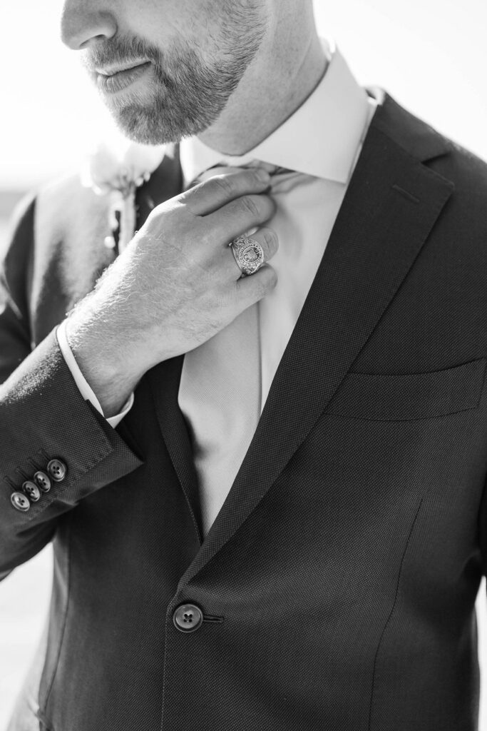 Groom adjusting his tie before his Lavender Hill Farm wedding
