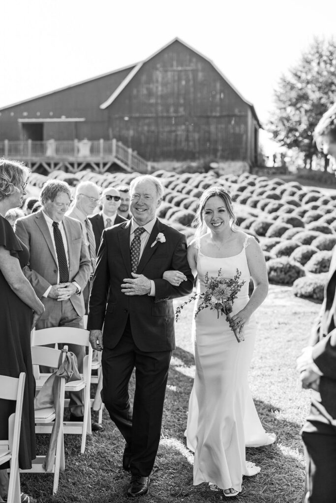 Bride walking down the aisle with her dad at a Lavender Hill Farm wedding