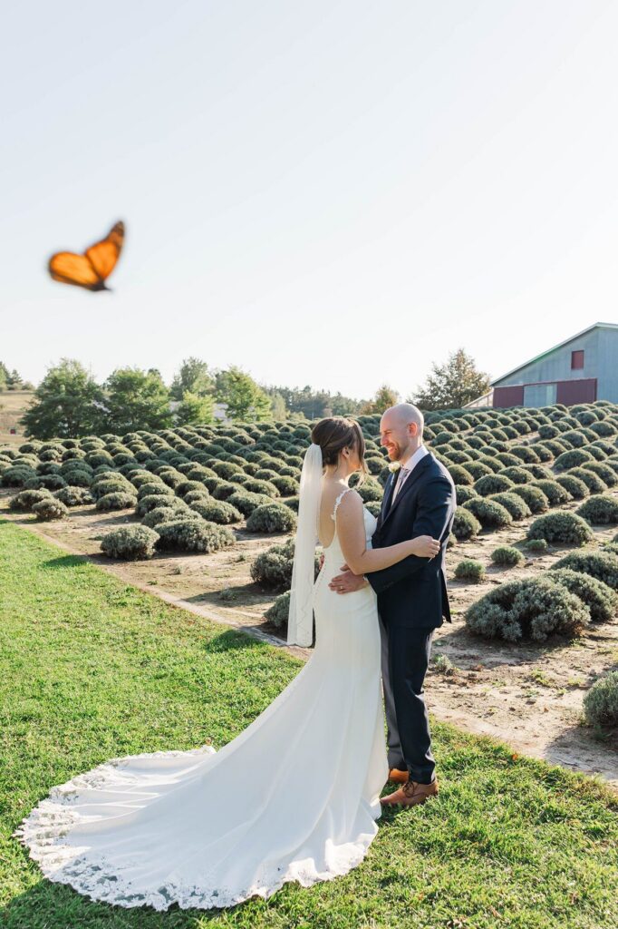 Butterfly flying over the bride and groom at their Lavender Hill Farm wedding