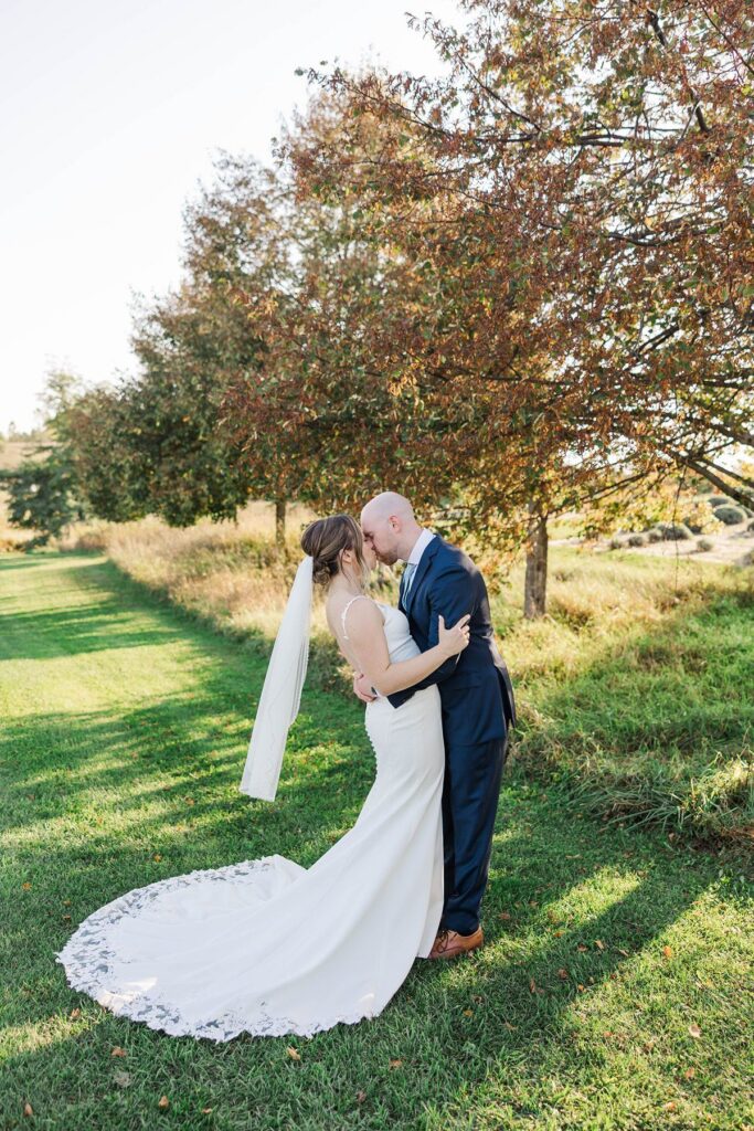 Bride and groom sharing a kiss after their Lavender Hill Farm wedding ceremony