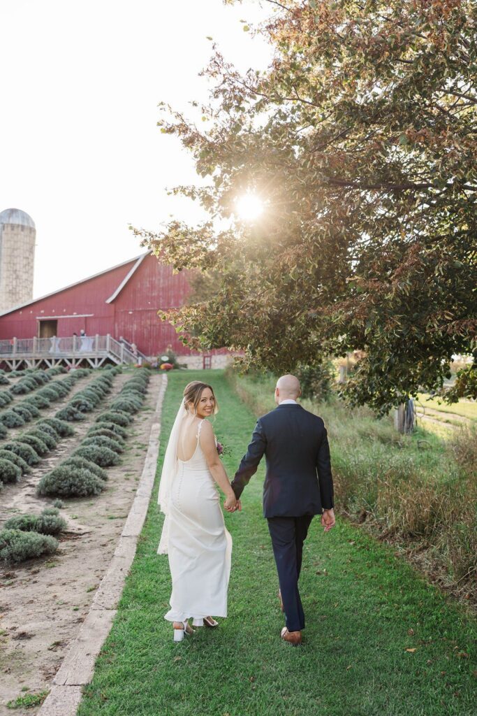 Bride and groom walking through the lavender fields at Lavender Hill Farm