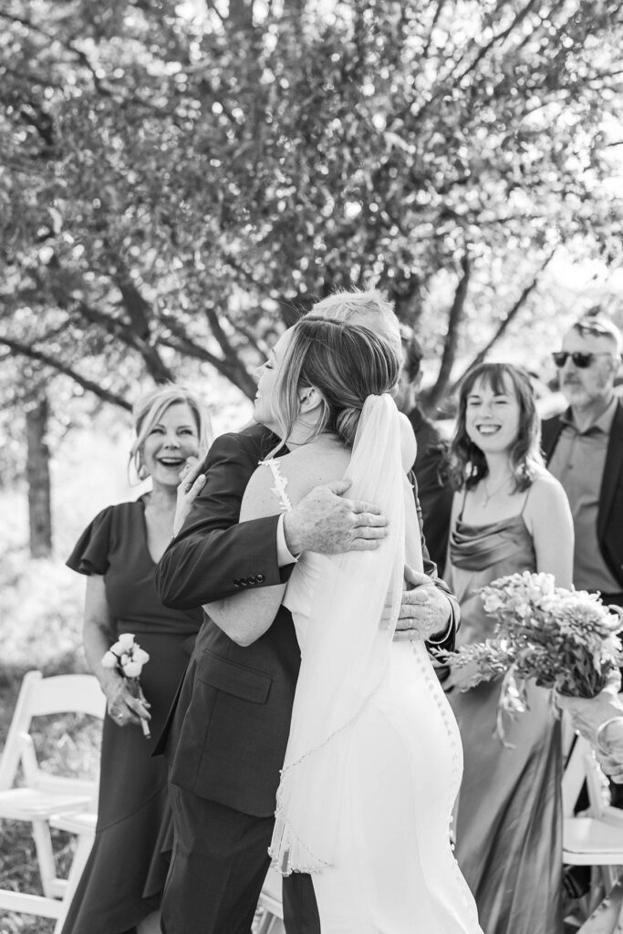 Bride hugging her dad during her Lavender Hill Farm wedding ceremony