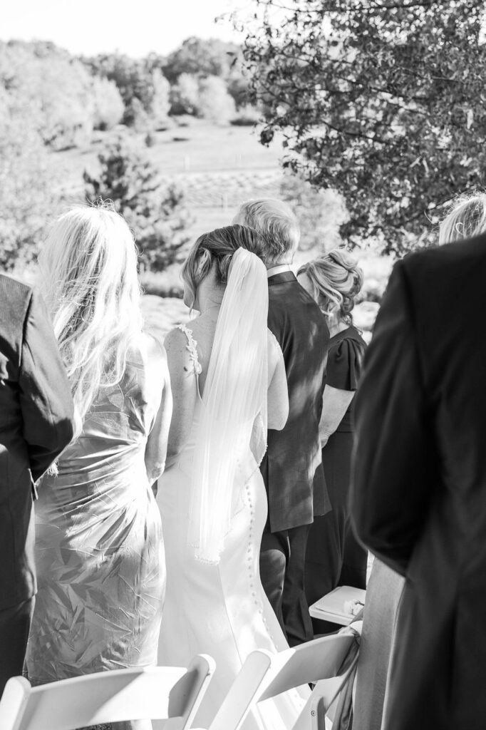 Bride leaning on her dad during her Lavender Hill Farm wedding ceremony