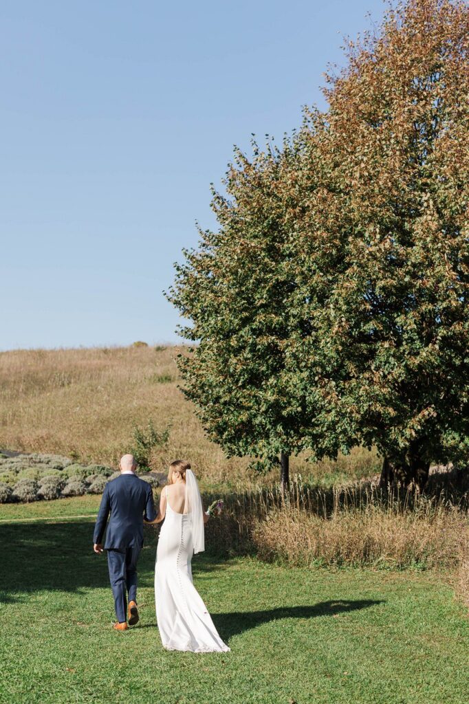 Bride and groom walking together after their Lavender Hill Farm wedding ceremony