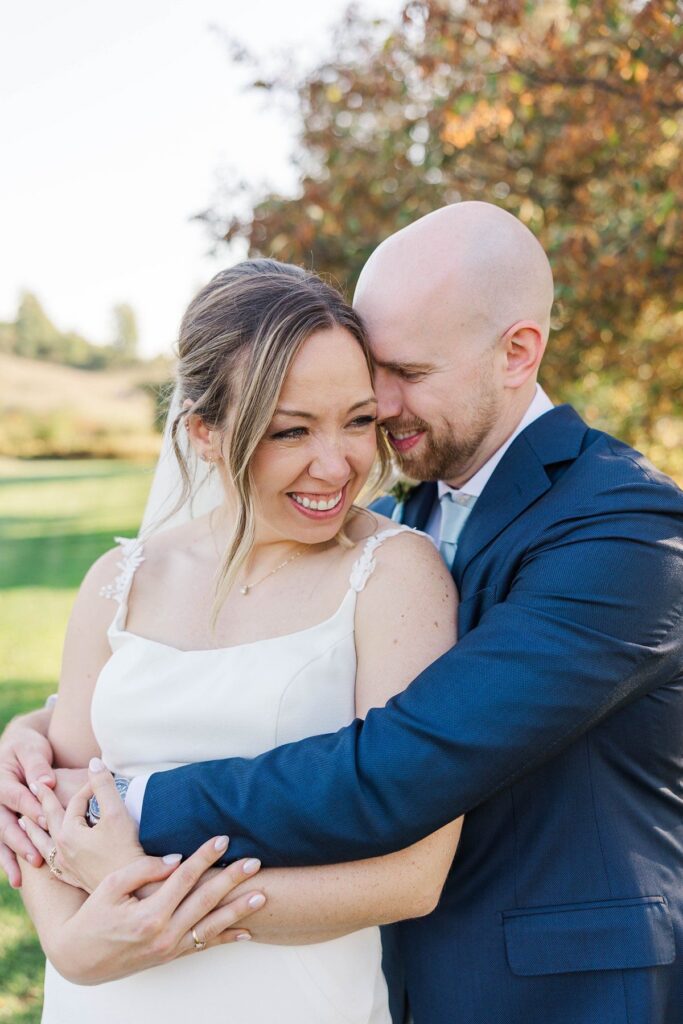 Bride and groom embracing after their Lavender Hill Farm wedding ceremony