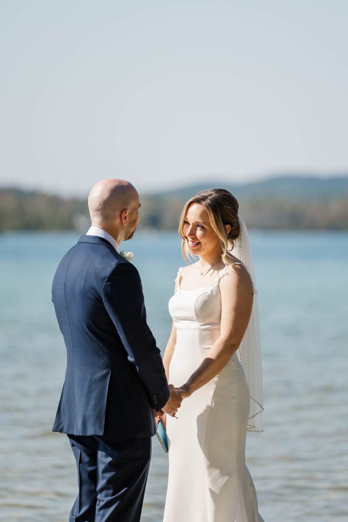 Bride and groom holding hands during portraits at Deer Lake before their Lavender Hill Farm wedding