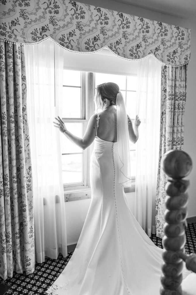 Bride looking out the window before her Lavender Hill Farm wedding at Boyne Mountain Resort