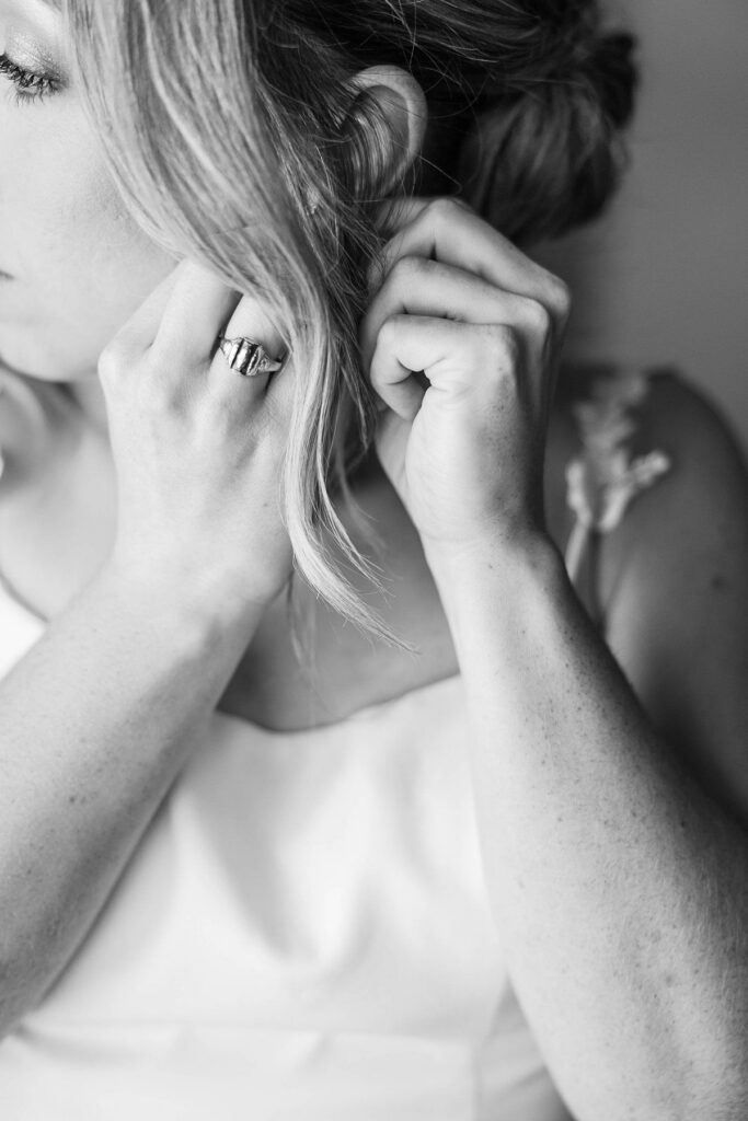 Bride putting on her earrings before her Lavender Hill Farm wedding