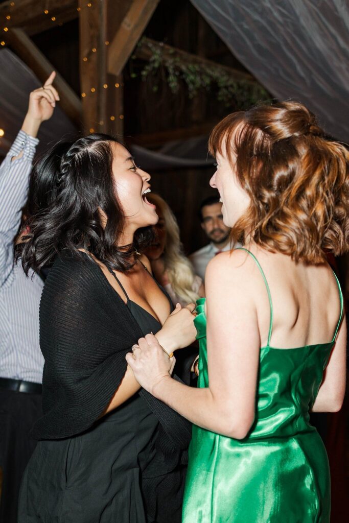 Wedding guests celebrating on the dance floor at Lavender Hill Farm's reception