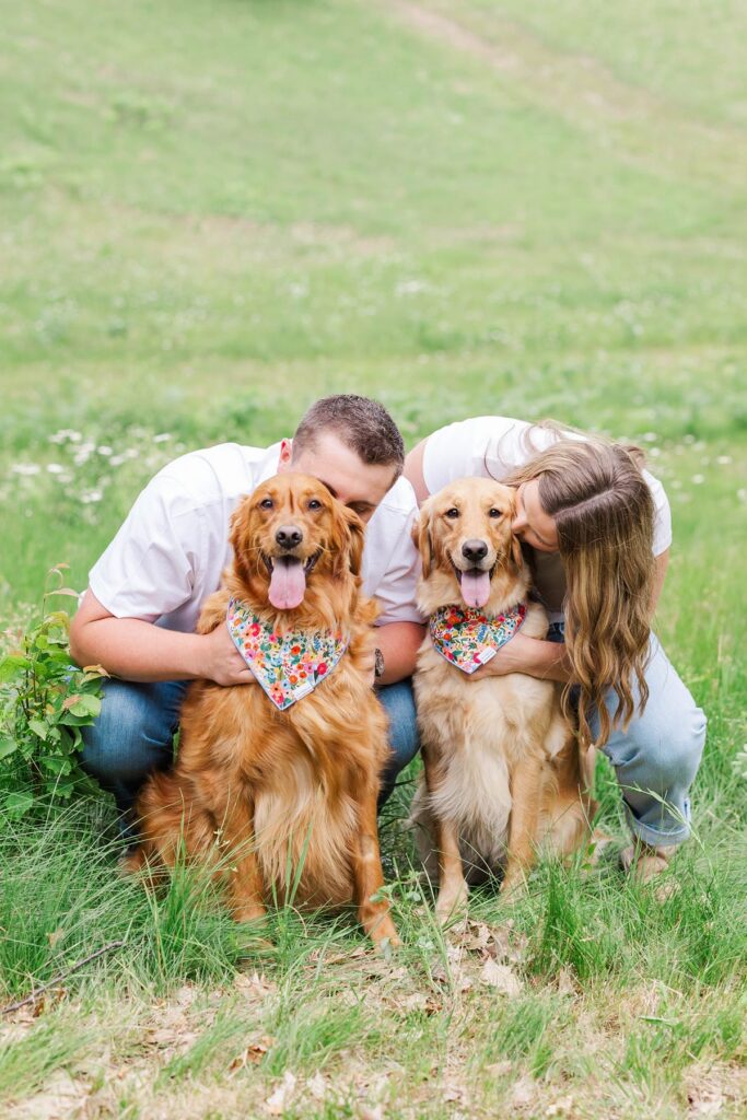 Madison and Jaxon with their two dogs during their engagement session on the property where they will build their future home.