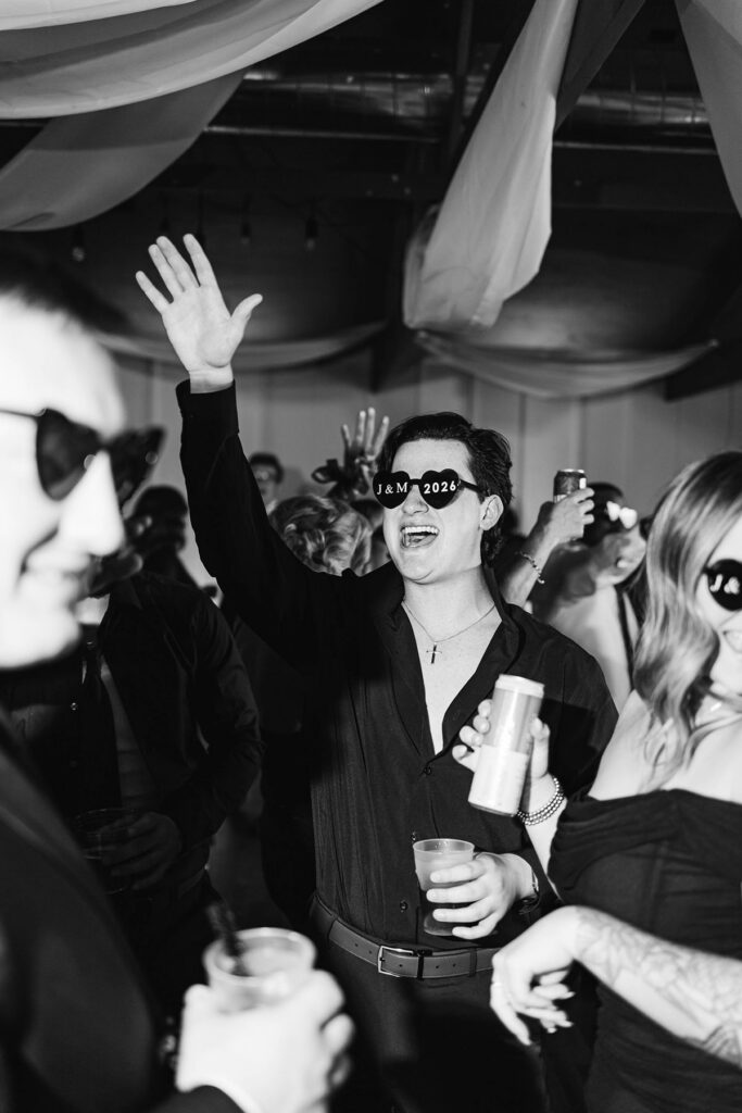 Wedding guests celebrating on a packed dance floor during Madison and Jaxon's reception at Mill Pond Event Center.