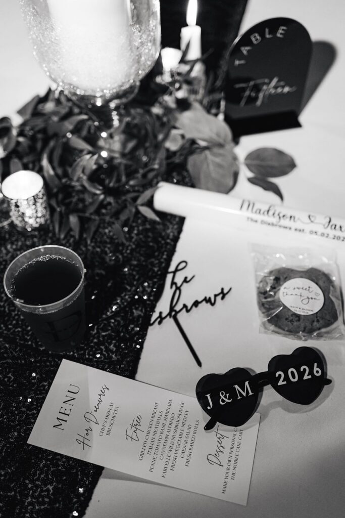 Candid late-night flat lay featuring custom wedding reception details at Madison and Jaxon's Mill Pond Event Center wedding in Kalkaska, Michigan.