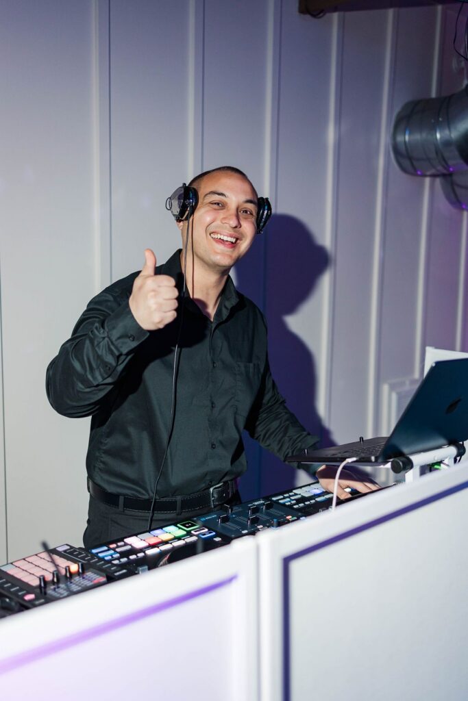 Wedding DJ Tony Lackie of Northern Beat Entertainment keeping the reception energy high during Madison and Jaxon's Mill Pond Event Center wedding in Kalkaska, Michigan.