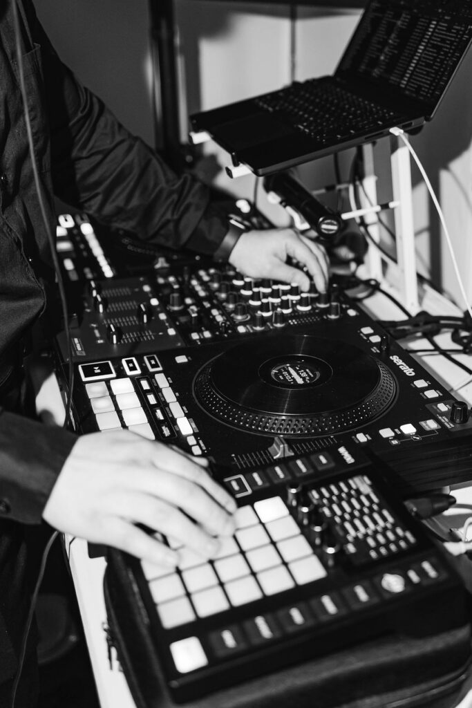 Black-and-white detail photo of DJ equipment by Northern Beat Entertainment during Madison and Jaxon's Mill Pond Event Center wedding reception in Kalkaska, Michigan.