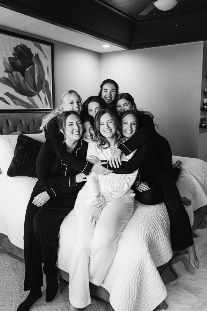 Bride sharing a joyful hug with her bridesmaids while getting ready before her Mill Pond Event Center wedding.