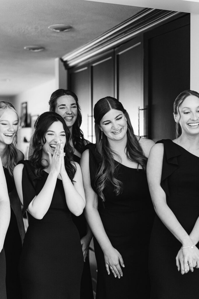 Bridesmaids' emotional first look as they see the bride in her wedding dress before the ceremony at Mill Pond Event Center.