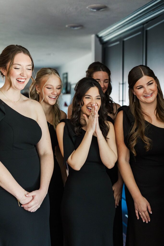Bridesmaids reacting as they see the bride for the first time before her Mill Pond Event Center wedding in Northern Michigan.