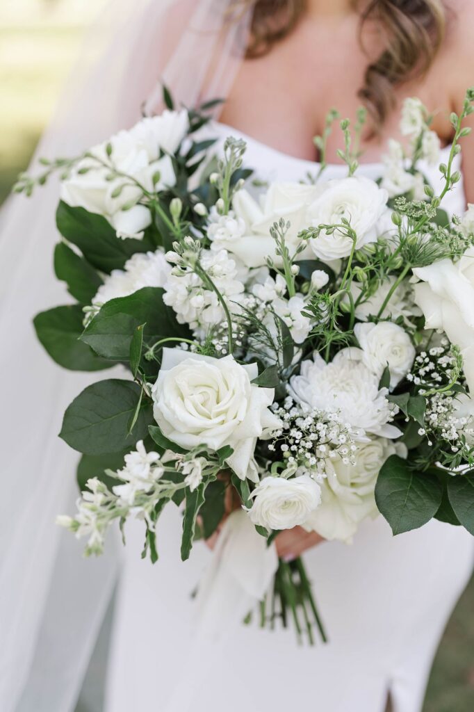 Lush white bridal bouquet designed by Sunday Morning Flowers for a Mill Pond Event Center wedding in Northern Michigan.