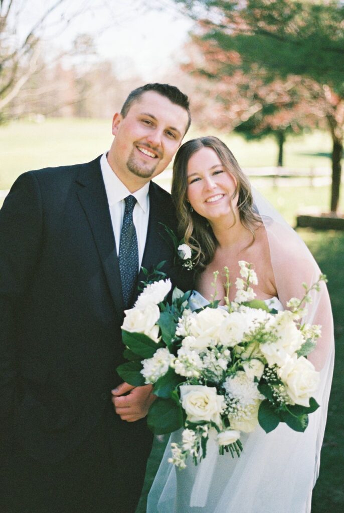 Film wedding portrait of Madison and Jaxon with the bride's bouquet at Mill Pond Event Center.