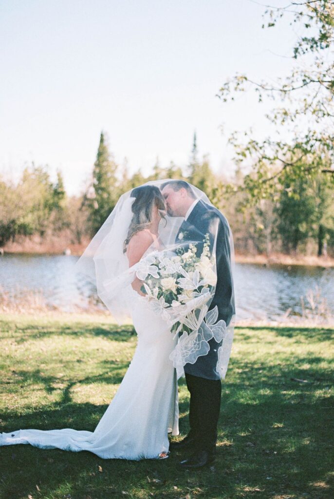 Film portrait of Madison and Jaxon sharing a quiet moment beneath her veil at their Mill Pond Event Center wedding.