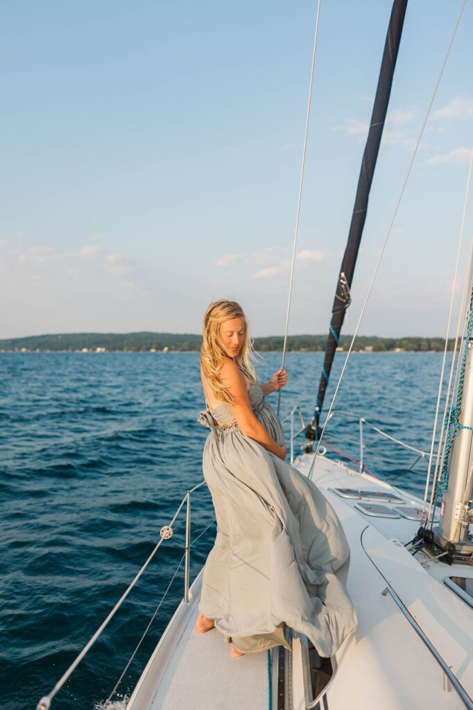 Bride from a Black Star Farms wedding during a sunset Traverse City sailboat photos session on Grand Traverse Bay