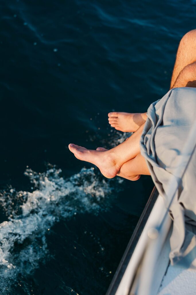 Couple enjoying a sunset sail on Grand Traverse Bay during a Traverse City sailboat photos session