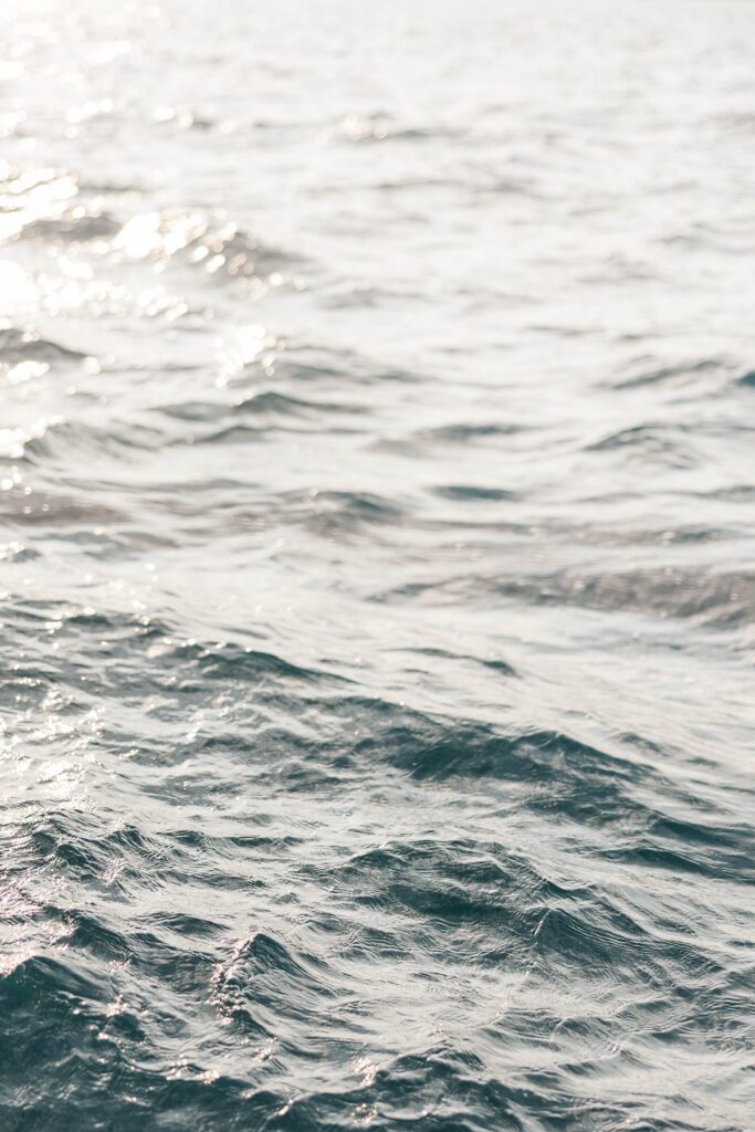 Sunlight reflecting across the waves of Grand Traverse Bay during a sunset sail in Traverse City