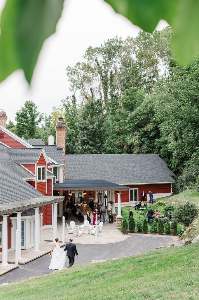 Allison and Cole walking toward the Covered Patio at Black Star Farms, a Northern Michigan wedding venue on the Leelanau Peninsula.