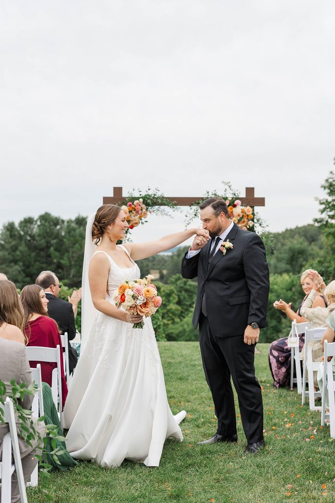 Allison gently wipes away Cole's tears during their outdoor wedding ceremony at Black Star Farms in Northern Michigan.