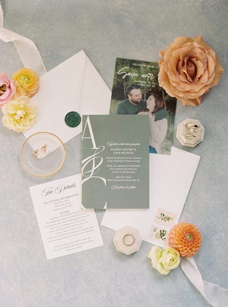 Allison and Cole's wedding invitation suite, rings, and colorful floral details photographed on film for their Black Star Farms wedding.