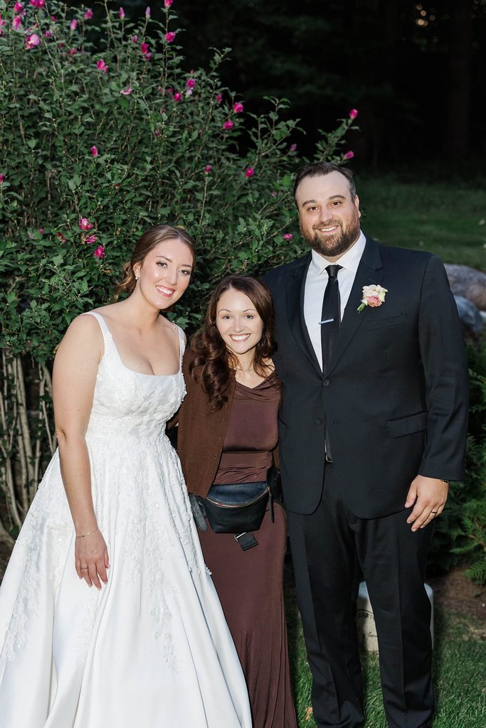 Northern Michigan wedding photographer Leah Rohde posing with Allison and Cole at their intimate Black Star Farms wedding in Suttons Bay, Michigan.